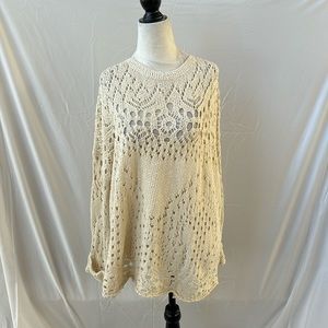 Free People oversized cream colored knit sweater with cuffed sleeves.